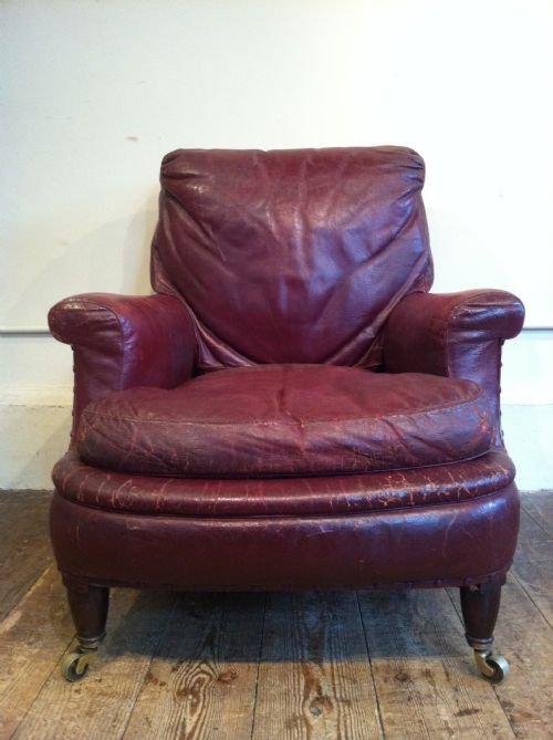 fig 1. A Victorian library armchair by William Birch c 1890 covered in the original red morocco leather with a down sack back and cushions on turned mahogany legs brass cappings and castors.