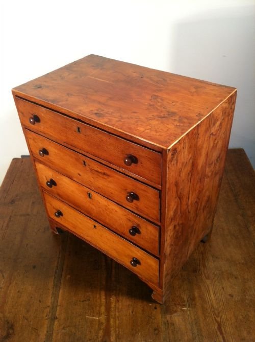 fig 1. A George 111 miniature burr yew wood and boxwood strung chest of 4 long drawers c 1810