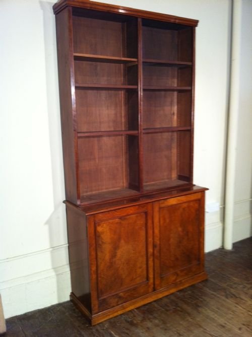 A Victorian Figured Burr Walnut Open Library Bookcase C 1870 the Top Section with Adjustable Shelves Above a Lower Section with a Pair of Cupboard Doors.
