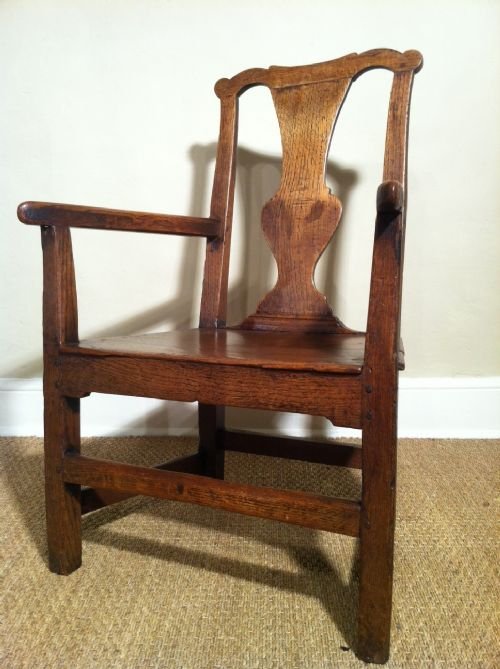 An 18th Century Oak Country Armchair with Shaped Back and Central Vase Splat with Good Patination and Colour