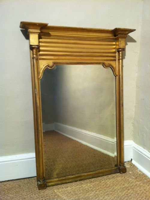 A Regency Gilt Pier Mirror C1830 Fitted Aroung an Early 18th C Bevelled Mirror Plate