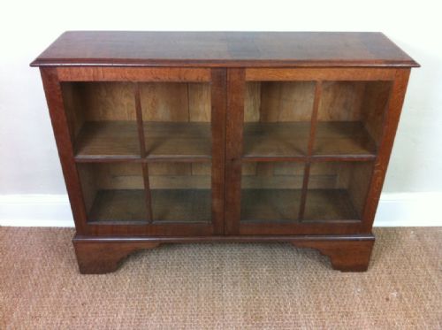 An Early Heals or Cotswold School Oak Bookcase C 1910
