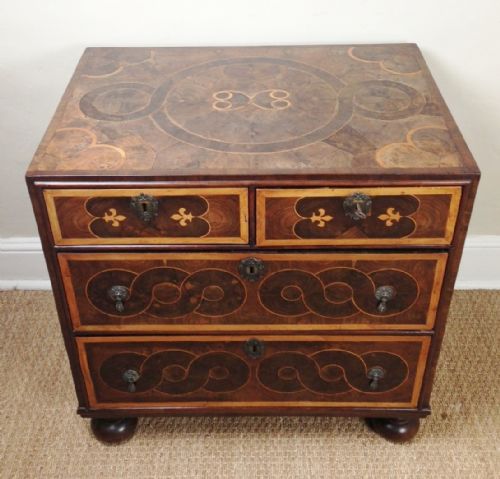 A Small and Rare William and Mary Oyster Veneered Walnut and Laburnum Cross Banded Chest of Two Short and Two Long Drawers C 1695 on Later Bun Feet.