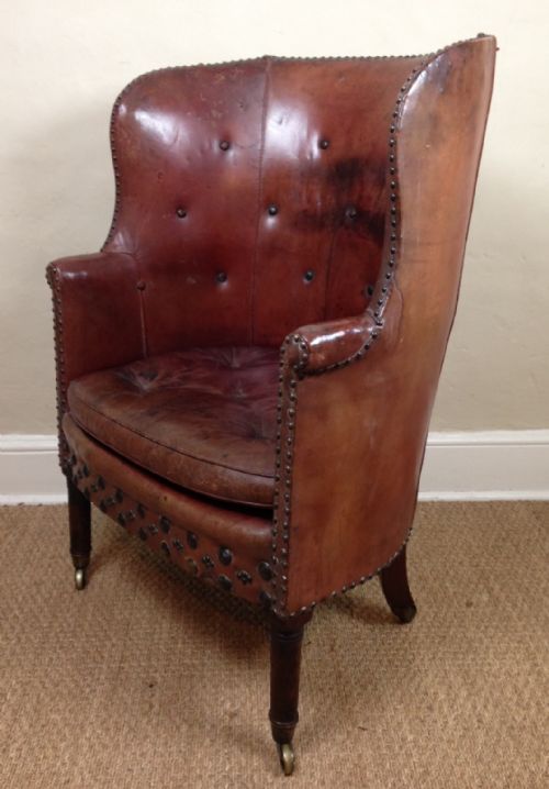 fig 1. A George IV barrel back wing chair in original morocco leather c 1830