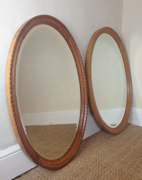A Pair of Late Victorian Oak Oval Mirrors C 1900