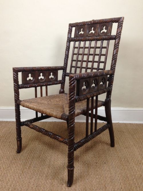 A Mid 19th C Gothic  Oak Elbow Chair with Original Rush Seat.
