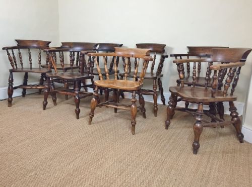 A Harlequin Set of Eight Elm Smokers Bow Chairs Mid to Late 19th Century