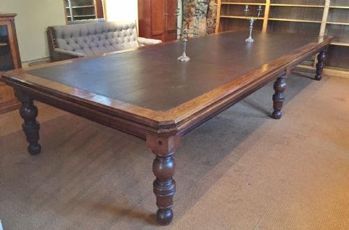 A Monumental Late 19th Century Walnut Boardroom Table with Original Tooled Brown Leather Top.