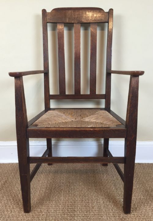 An Arts and Crafts Oak Rush Seated Elbow Chair Circa 1910