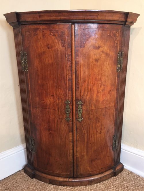 A Queen Anne Walnut and Marquetry Hanging Corner Cupboard Circa 1715