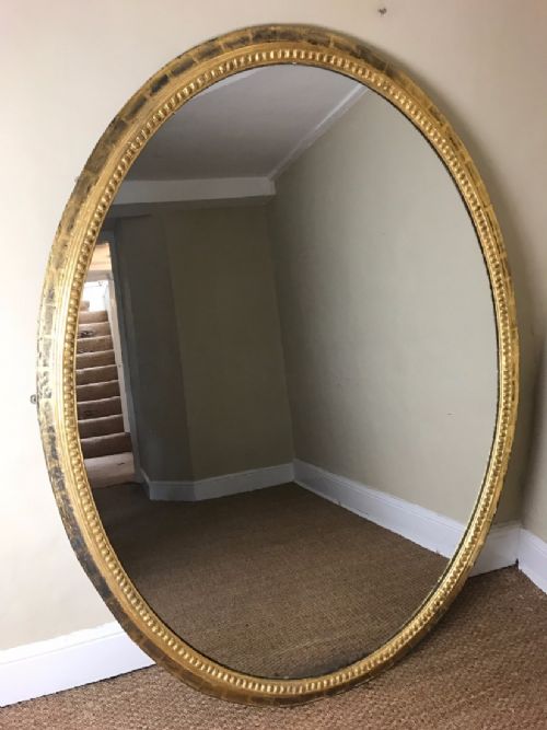 An Extremely Large Mid 19th Century Water Gilt Oval Mirror.