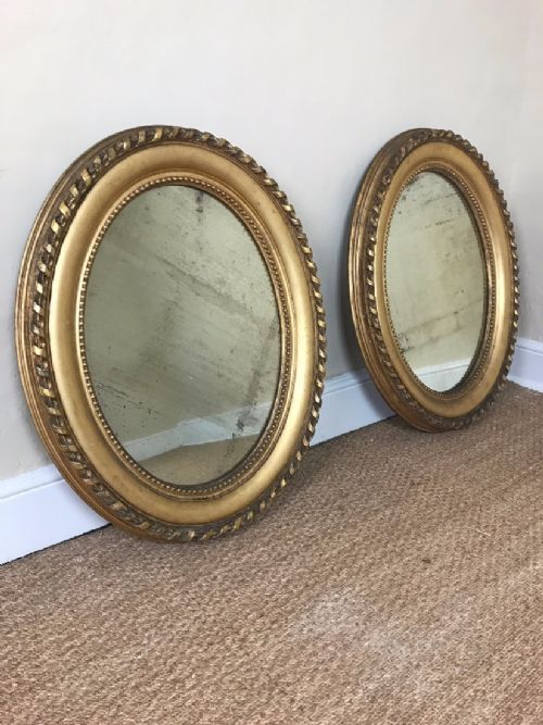 A Pair of Victorian Carved Gilt Wood Oval Mirrors Circa 1870