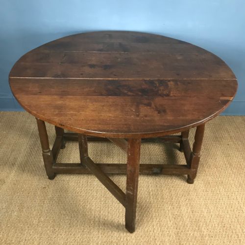 An Early 18th C Oak Gateleg Table with Oval Drop Flap Top.