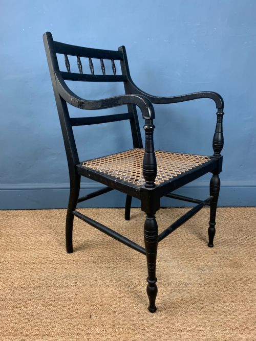 An Aesthetic Movement Ebonised and Caned Arm Chair Circa 1890