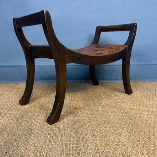 An Arts and Crafts Oak and Leather X-frame Stool in the Style of Simpsons of Kendal Circa 1910