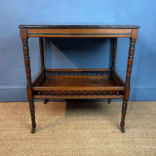 AN AESTHETIC MOVEMENT WALNUT AND EBONISED 2 TIER TABLE CIRCA 1890