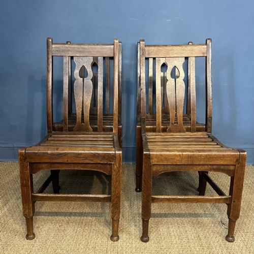 AN UNUSUAL SET OF 4 AESTHETIC MOVEMENT OAK CHAIRS BY JAS SHOOLBRED LTD CIRCA 1890