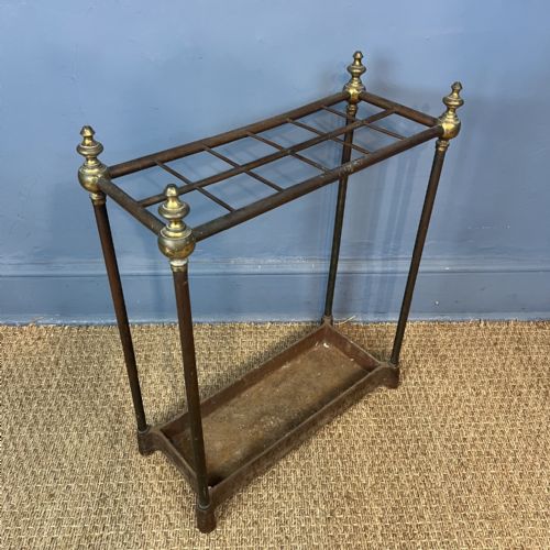 A LATE VICTORIAN BRASS AND CAST IRON 10 DIVISION STICK STAND CIRCA 1890