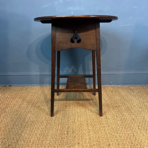 An Arts and Crafts oak circular 2 tier table circa 1900