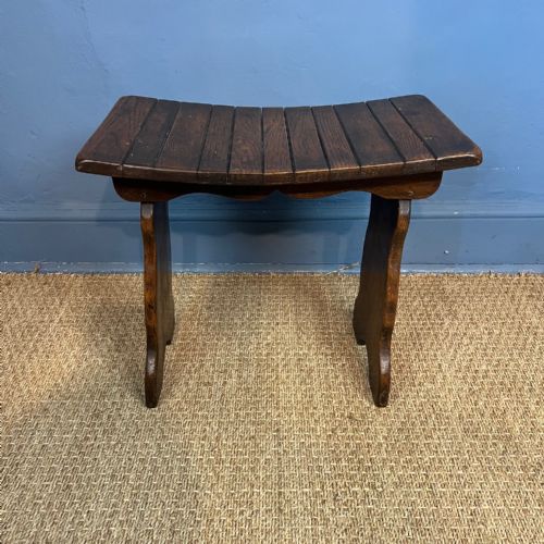 An Arts and Crafts Oak Saddle Seated Slatted Stool Circa 1900