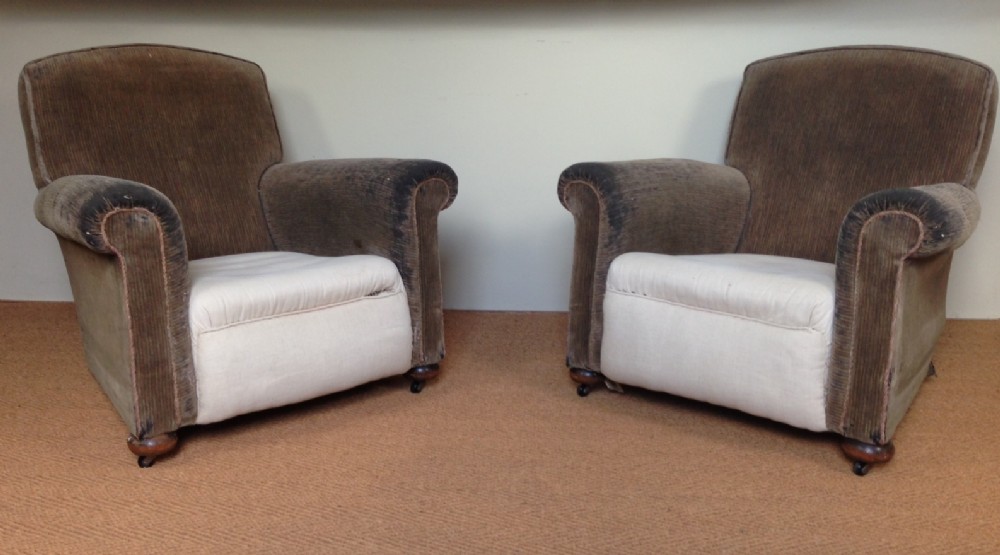 A pair of 1920`s oak armchairs for recovering.