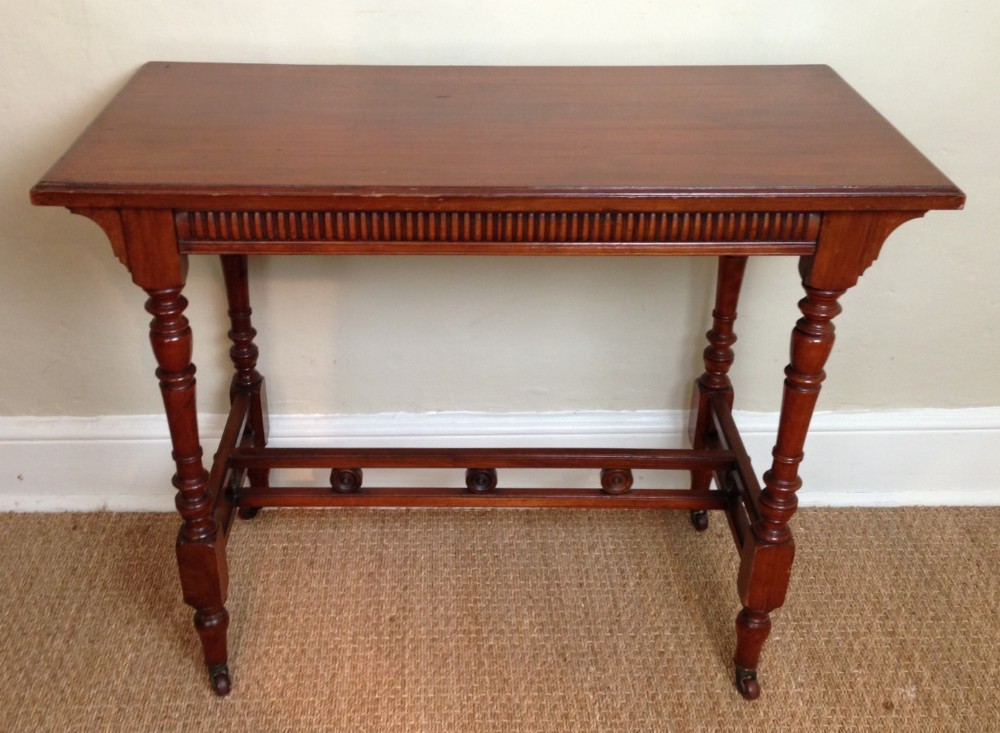An Aesthetic movement walnut table by James Shoolbred c 1890