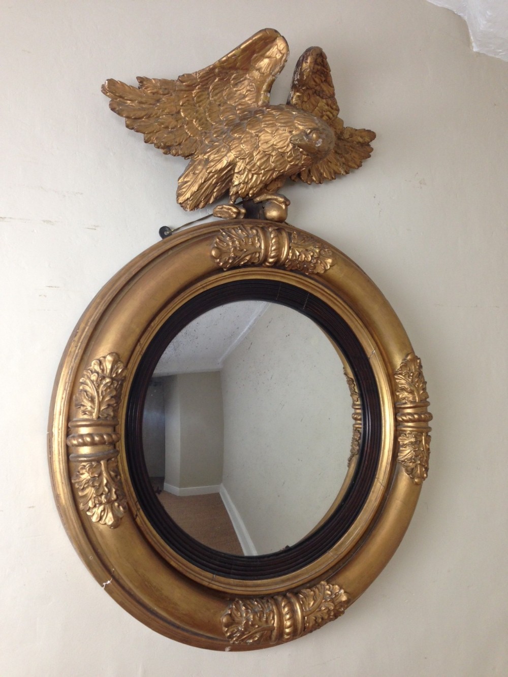A Regency gilt wood convex mirror  with eagle surmount c 1820