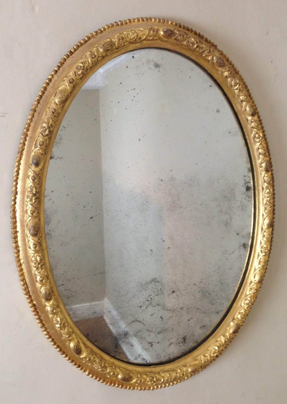 A Mid 19th c gilt oval mirror c 1840