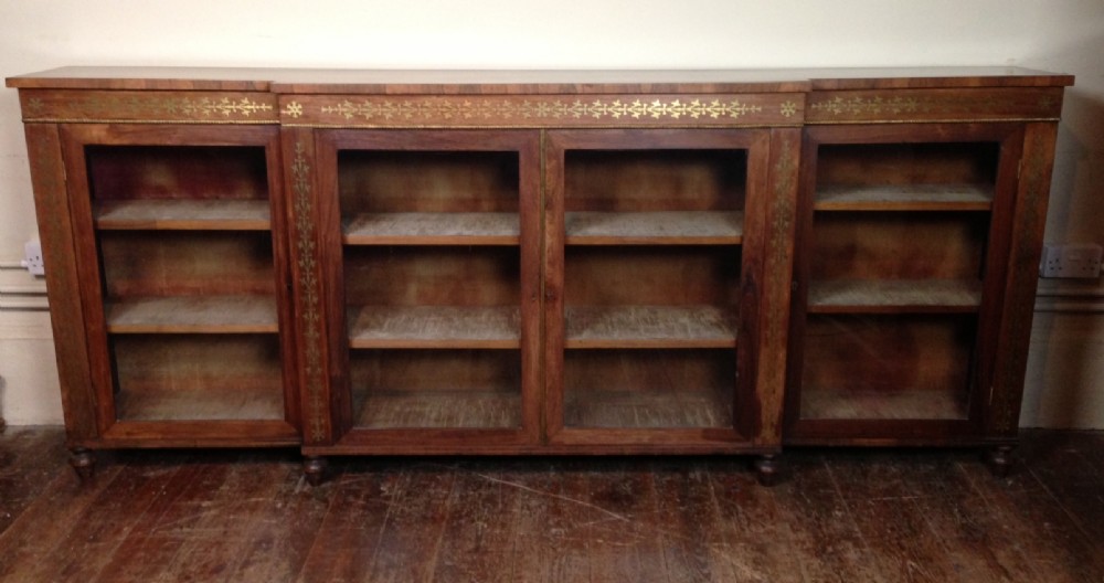 A large Regency rosewood and brass inlaid side cabinet c 1820