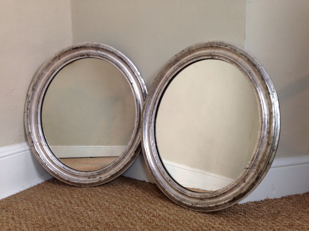 An unusual pair of Victorian silvered oval mirrors c 1870