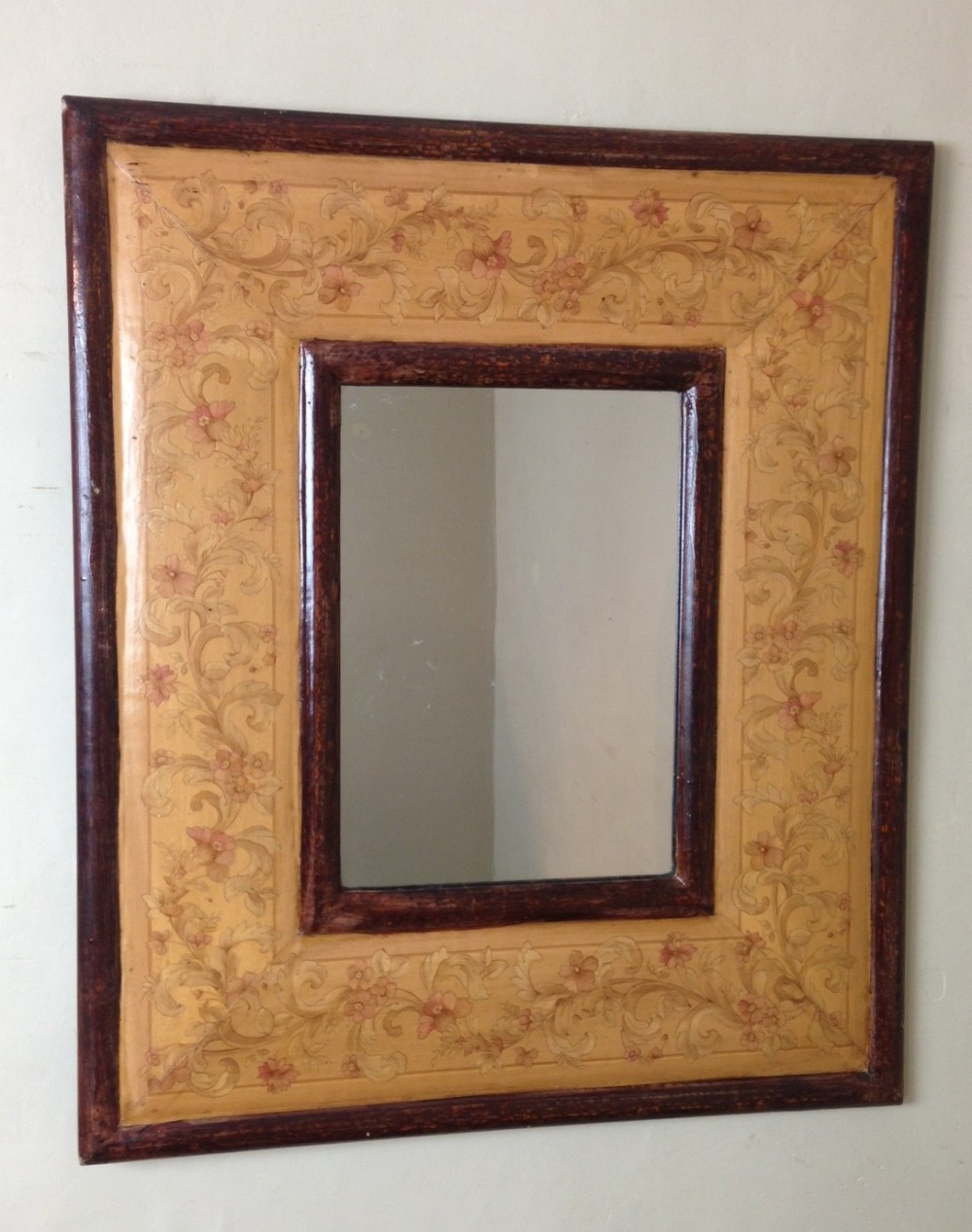 An Arts and Crafts poker work and painted mirror c 1910