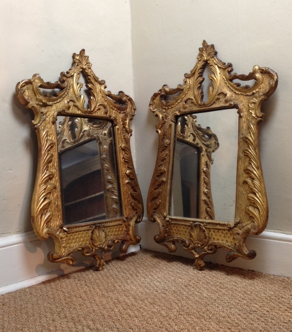 A pair of 19th c Florentine cartouche shaped wall mirrors c 1870