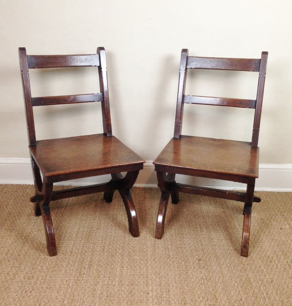 A pair of Gothic oak Hall chairs c 1880