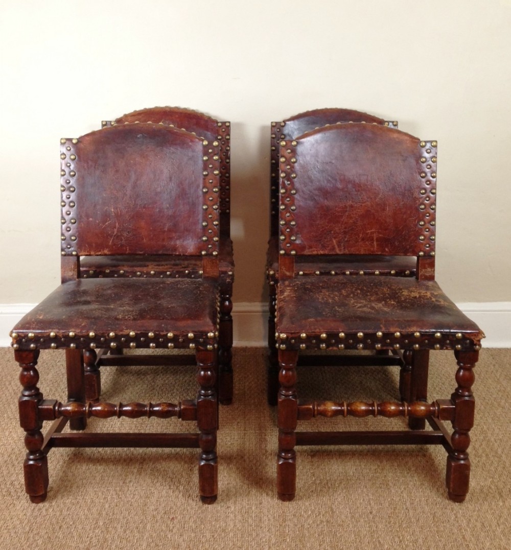 A set of 4 Cromwellian style oak and leather chairs c 1890