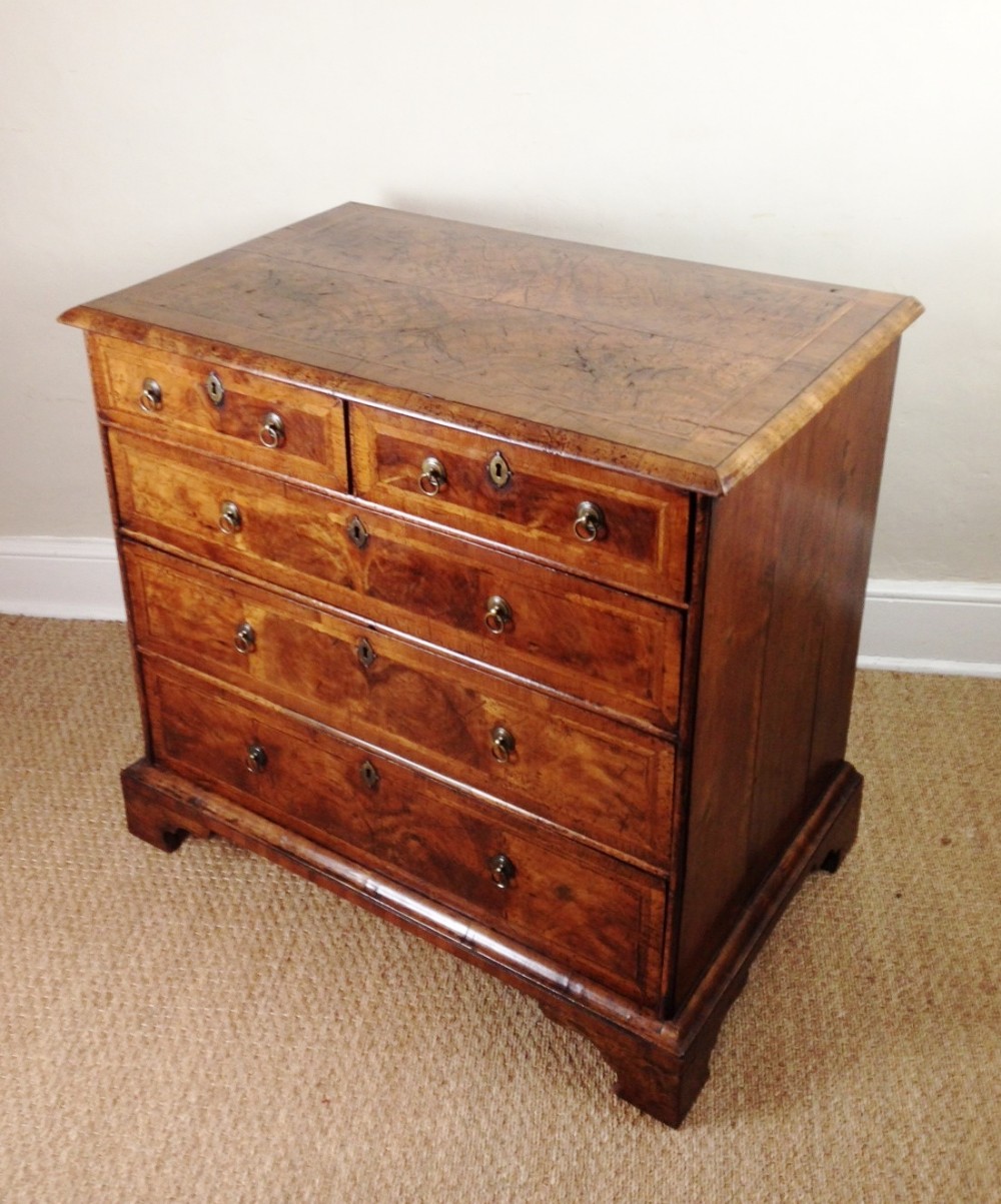 A Queen Anne walnut chest of drawers c 1715