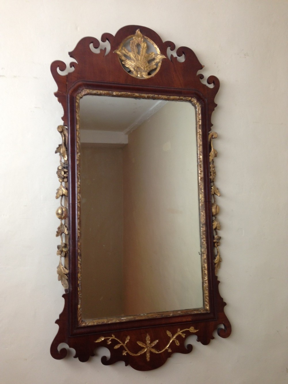 A late George 11 mahogany and parcel gilt wall mirror c 1760