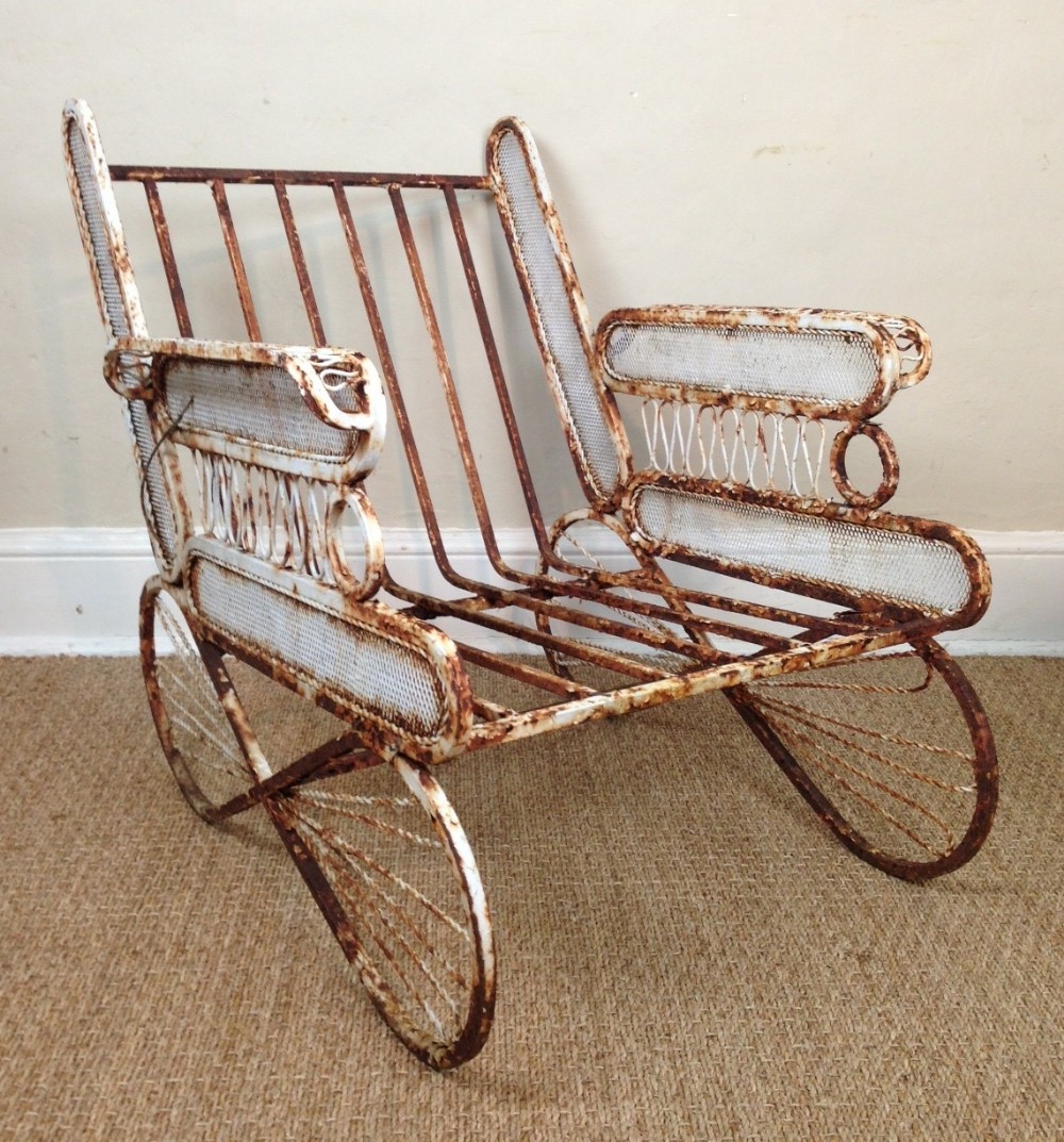 A set of 4 white 1930's French iron garden chairs