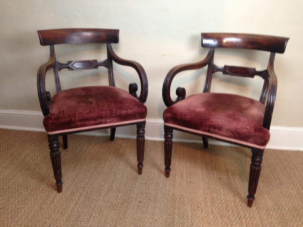 A pair of George IV mahogany elbow chairs c 1825