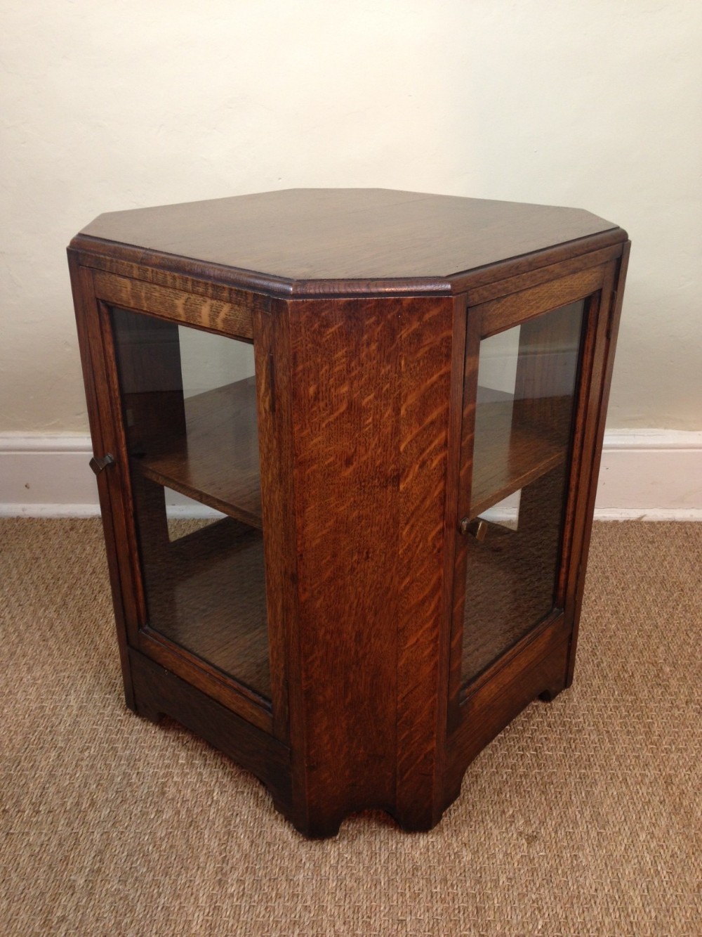 An unusual glazed octagonal oak book table c 1930