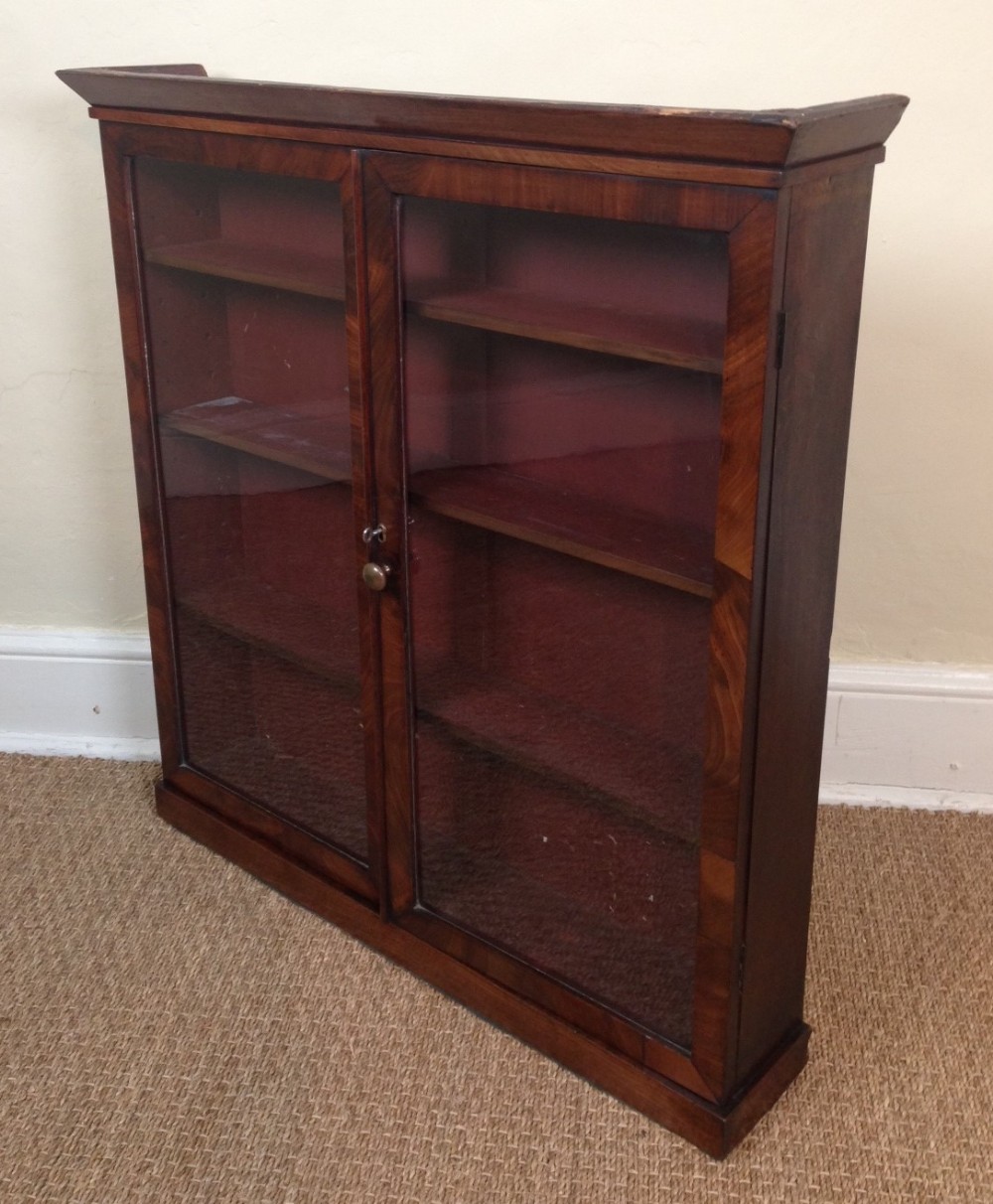 A rare George 111 mahogany glazed wall display cabinet c 1790