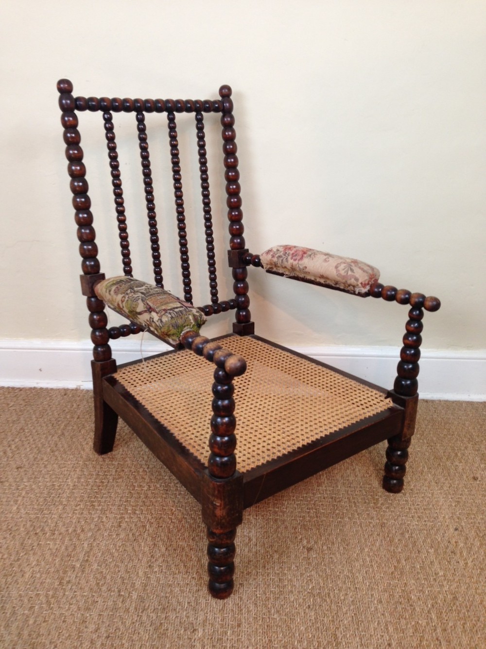 An early Victorian bobbin chair c 1850 with the original squab cushions