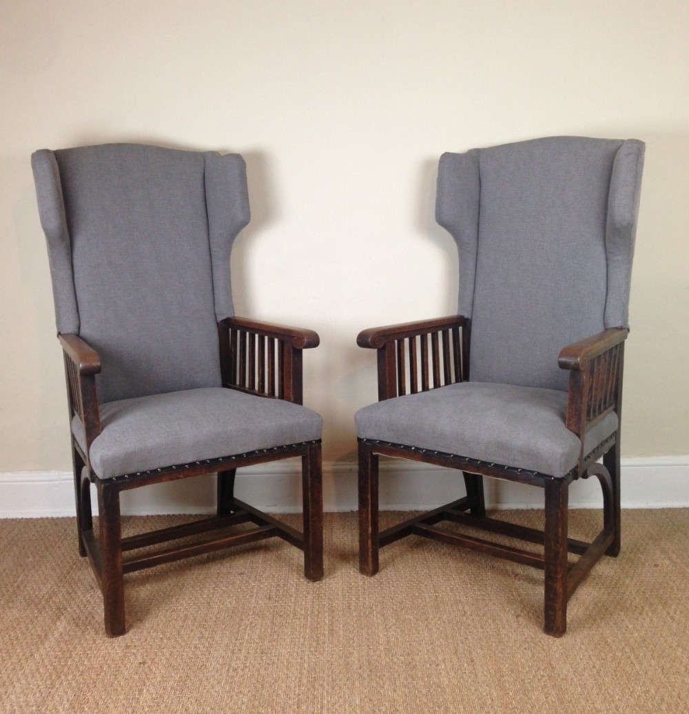 A pair of Arts and Crafts oak arm chairs c 1905