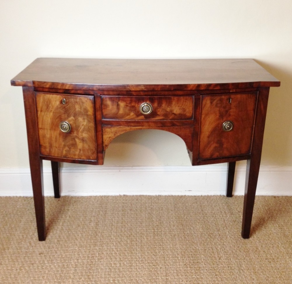 A Regency mahogany bow front sideboard or dressing table c 1810