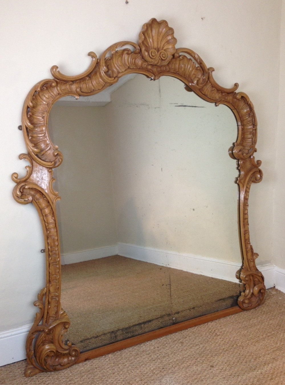 A large English pine rococo over mantel mirror c 1850