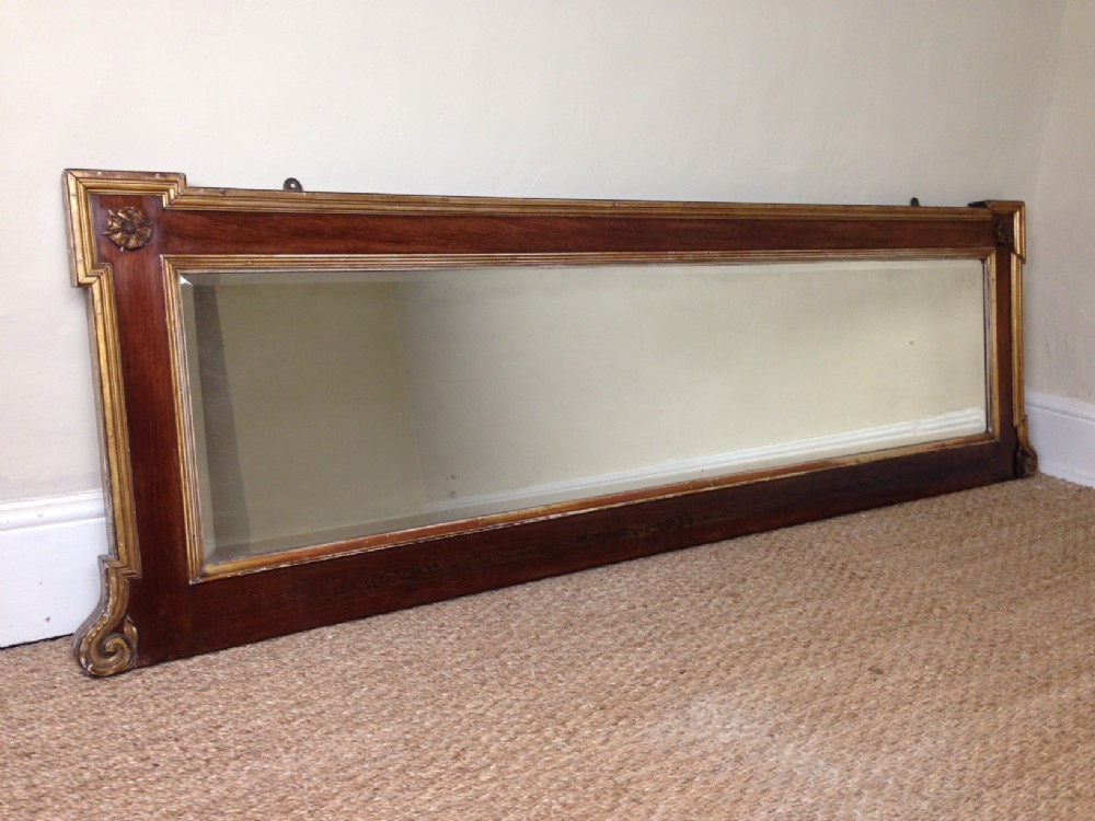 A mid 19th c walnut and parcel gilt mirror c 1860 by Howard and Sons