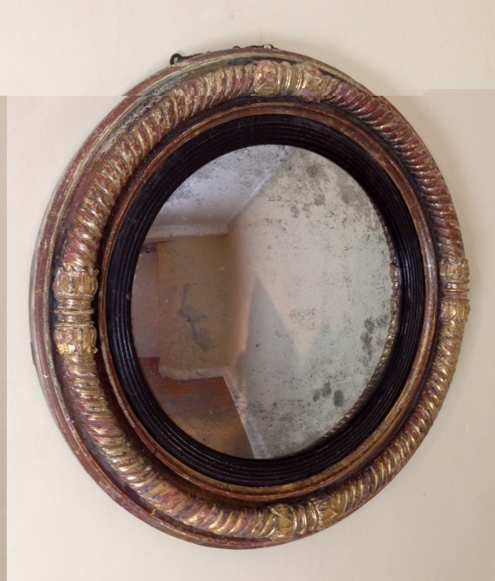A Regency gilt convex mirror c 1820 in completely original condition.