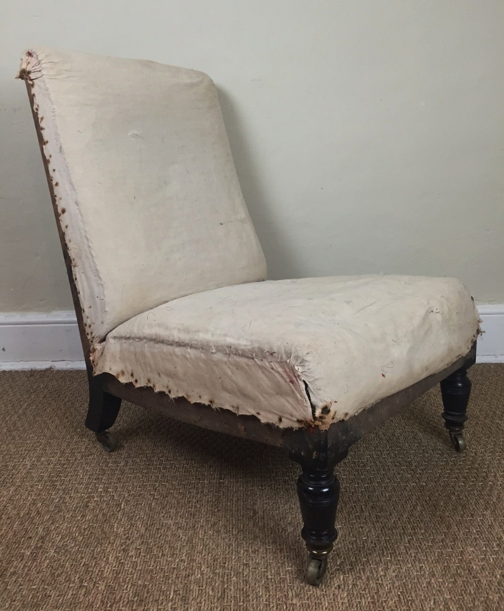 Gillows. A 19th c ebonised nursing chair stamped Gillow & Co 