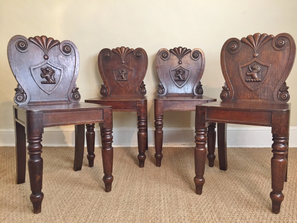 A rare set of 4 Irish Regency oak hall chairs c 1830