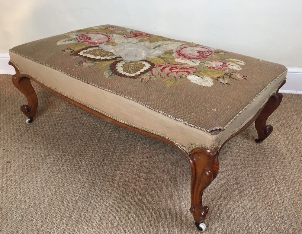 A large Victorian walnut cabriole leg stool c 1860 with original needlework top
