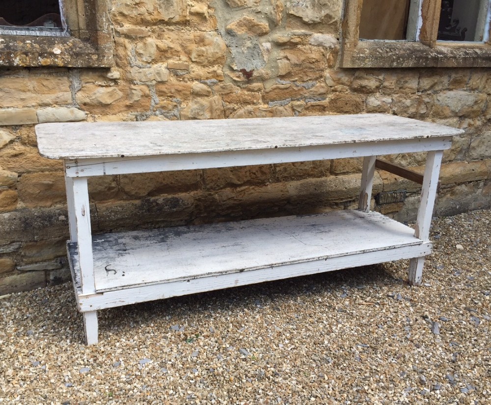 A useful and well worn 1930`s white painted potting table 